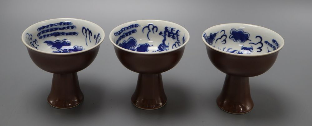 Three Chinese dragon stem cups, with blue and white interior, height 9cm